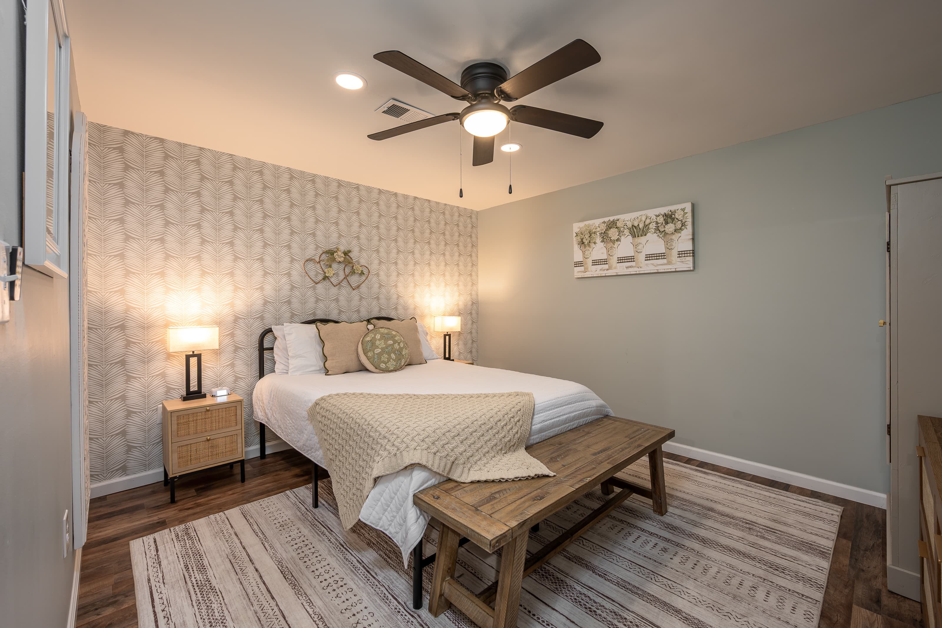 Lower level queen bedroom, w/nightstands, lamps, dresser, armoire & Roku TV. Next to bunk area.