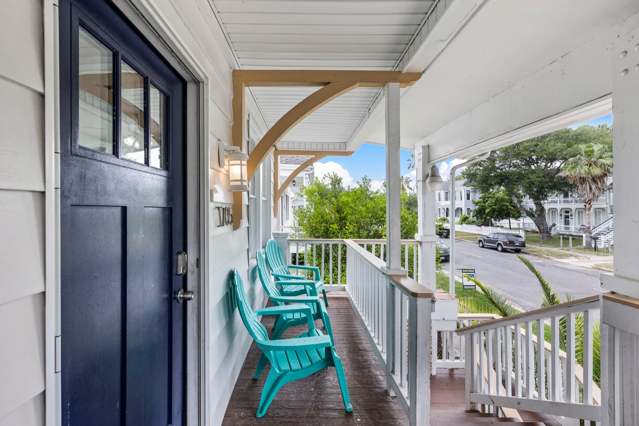 Starboard at M (Upper Right) — a covered porch with teal Adirondack chairs for easy island mornings.