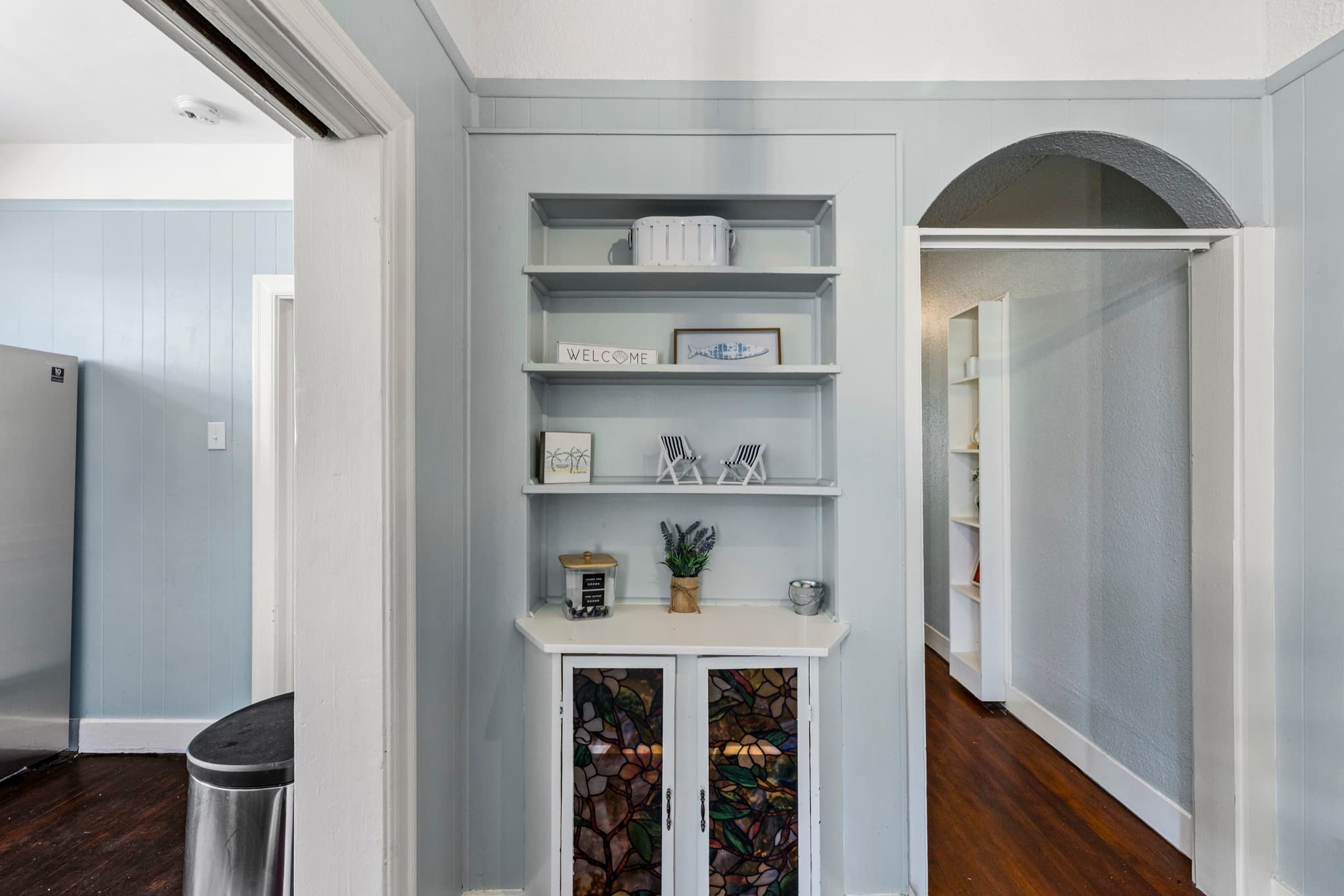 Port Side at M (Upper Left) — a full kitchen with stainless steel appliances and charming built-in storage.