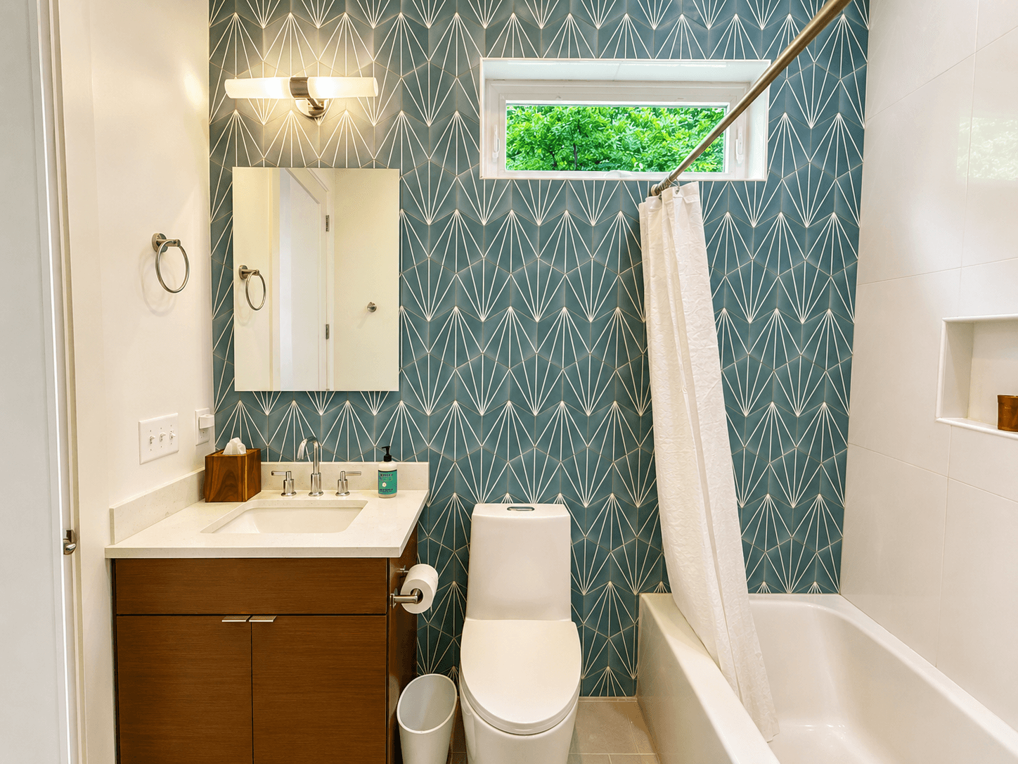 Convenient and stylish.
This full bathroom is located on the main level with access from both the foyer and the queen guest bedroom, making it easy and comfortable for guests to settle in.