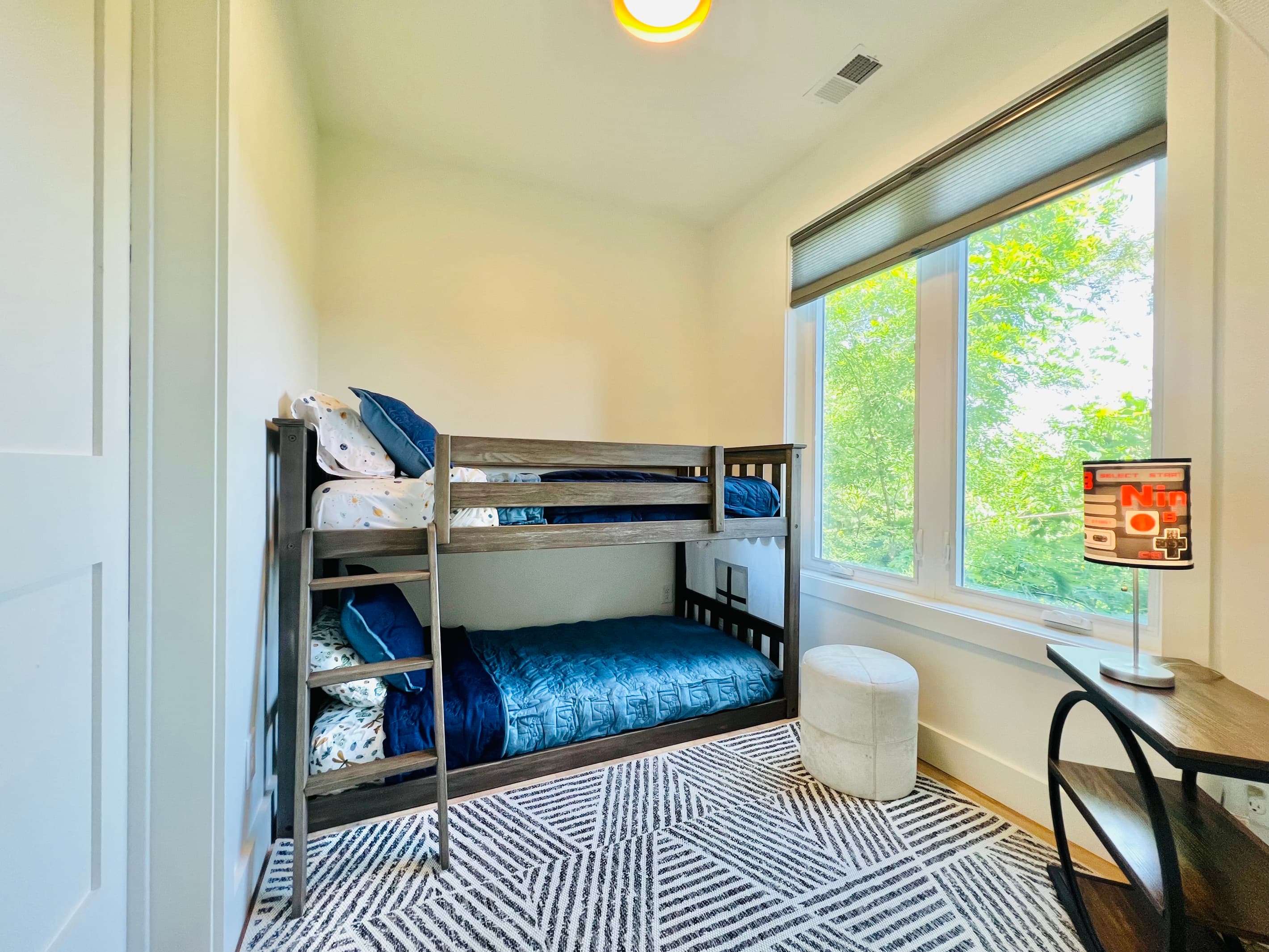 The kids may claim this room as their own.
Twin-over-twin bunks, a dedicated desk space, and easy access to the adjoining bathroom make this lower-level bunk room a fun and comfortable retreat for younger guests at Hidden Point House.