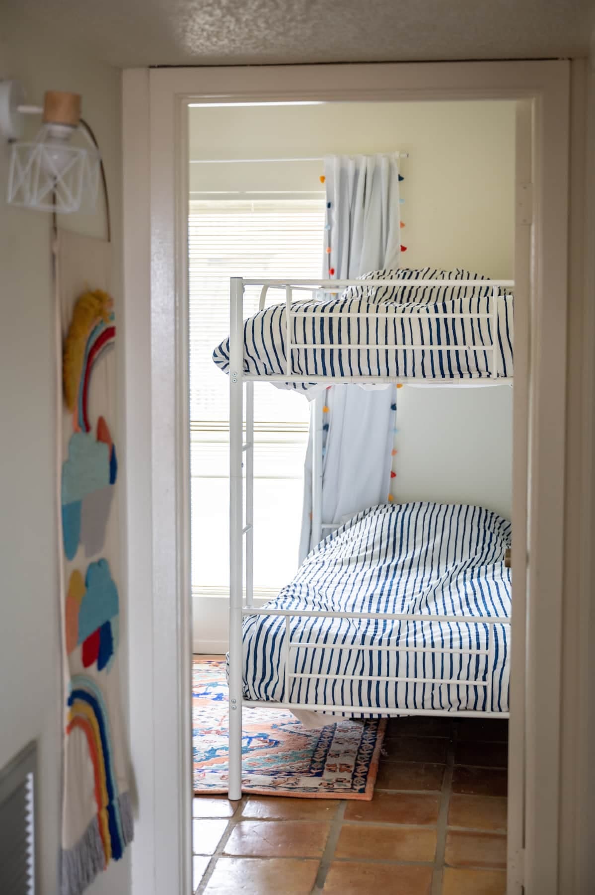 2 twin beds + a bunk bed (now a sturdy wooden bunk) = 4 single beds!