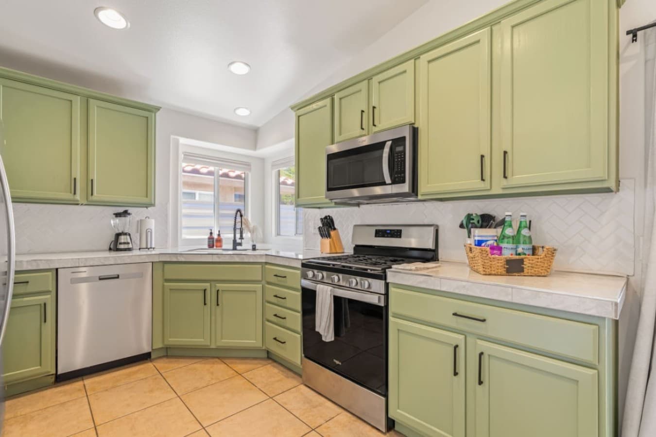 Cheerful kitchen w/ mint cabinetry, full appliances & plenty of counter space for easy meals.