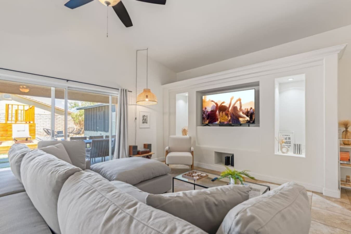 Inviting living room w/ plush seating, ceiling fan & easy access to the backyard through sliders.