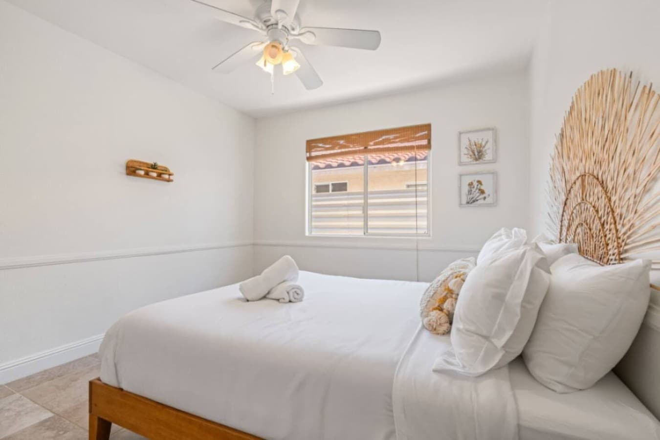Peaceful bedroom w/ soft linens, neutral tones & simple decor for restful nights.