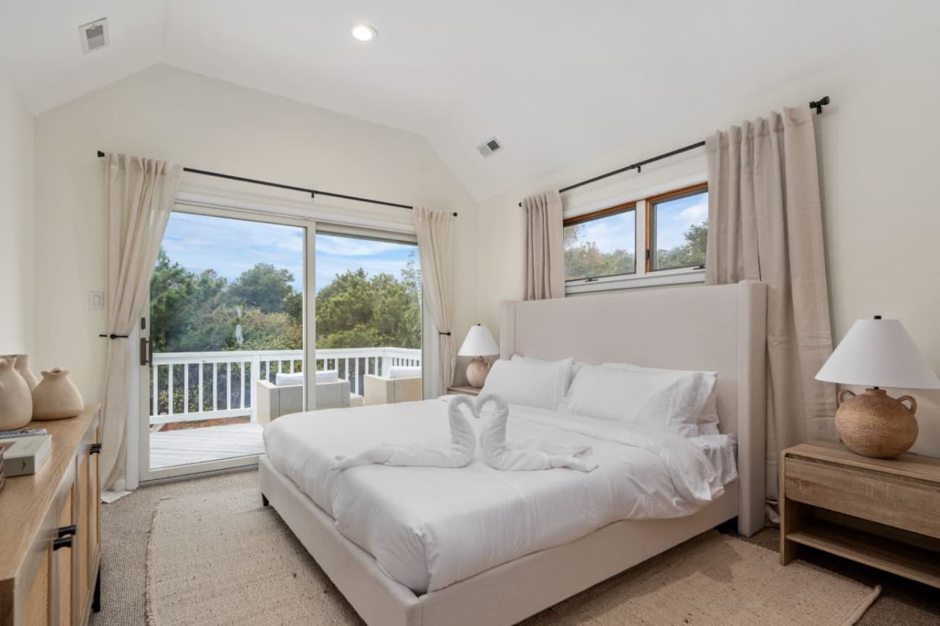 Airy bedroom w/ crisp whites, soft light & a calm, restful feel.