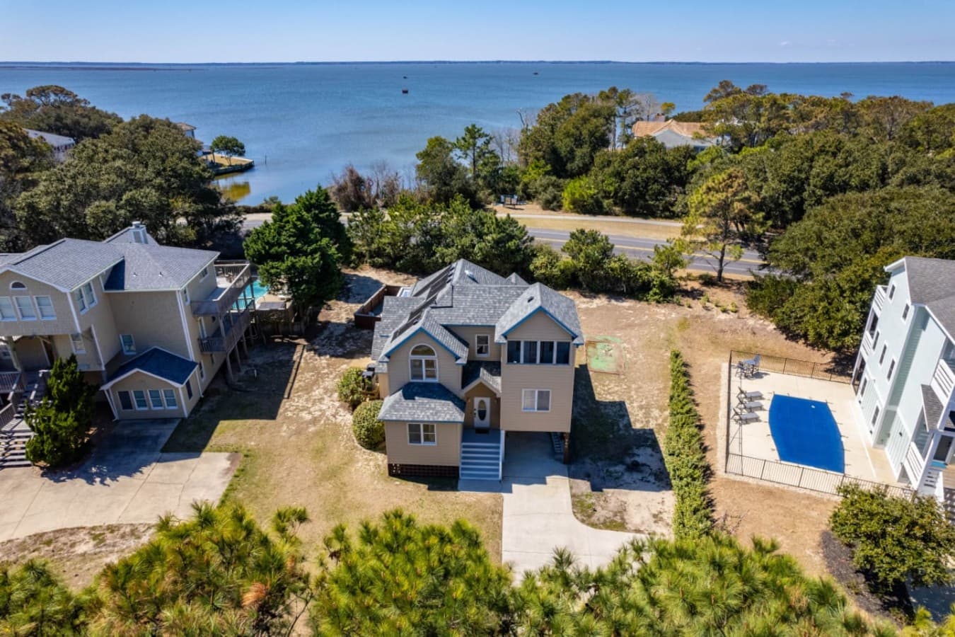 Aerial view showing the home nestled among neighboring coastal houses.