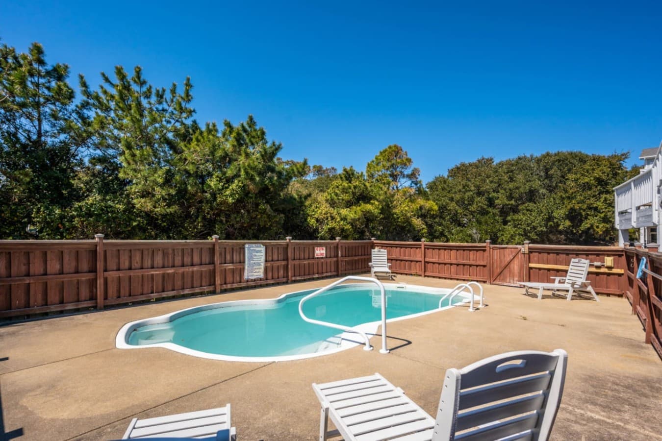 Spacious fenced pool area w/ plenty of room to relax poolside.