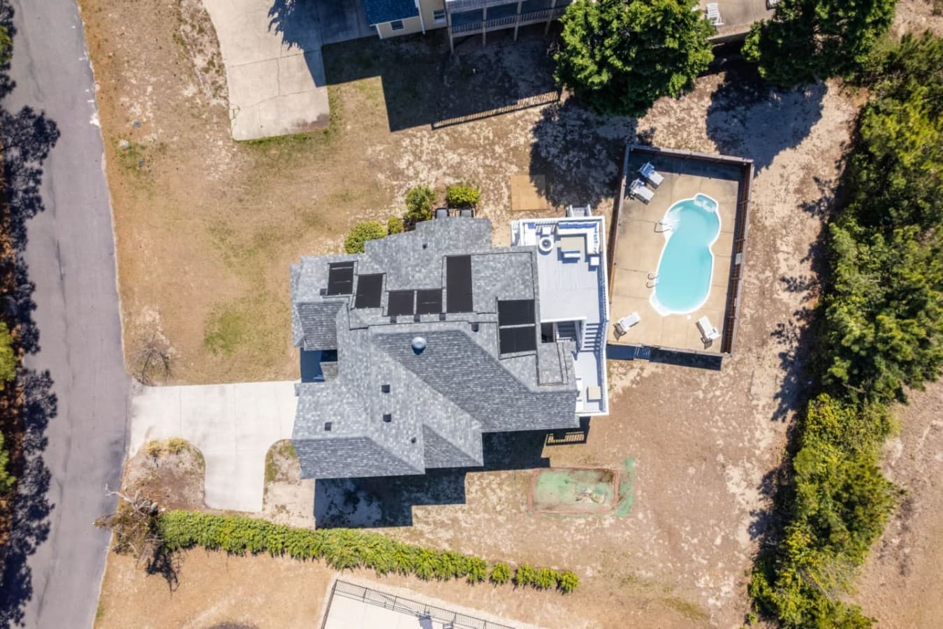 Top-down aerial highlighting the home layout & private pool area.
