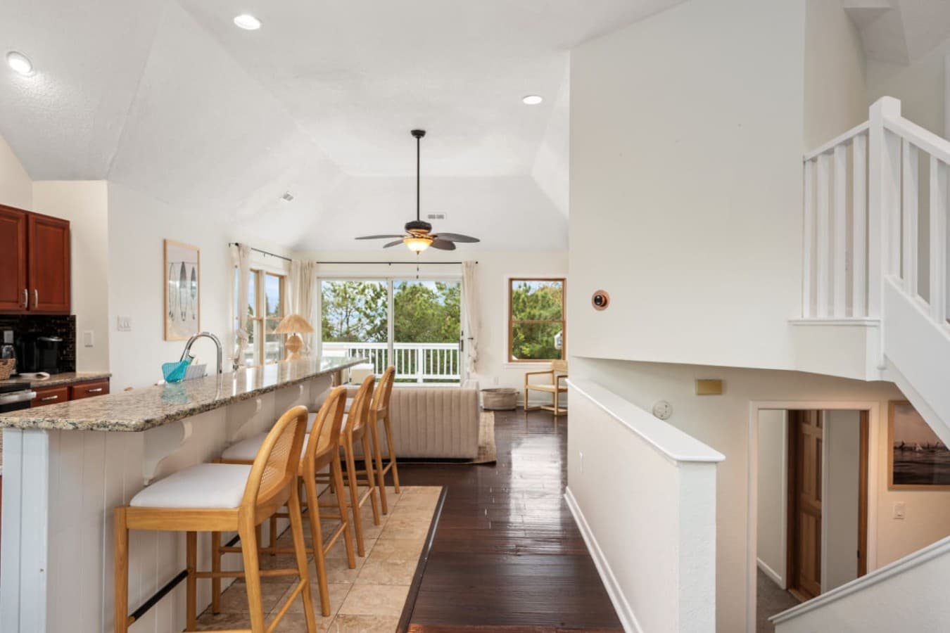 Open kitchen & dining space w/ warm wood tones & easy flow between rooms.