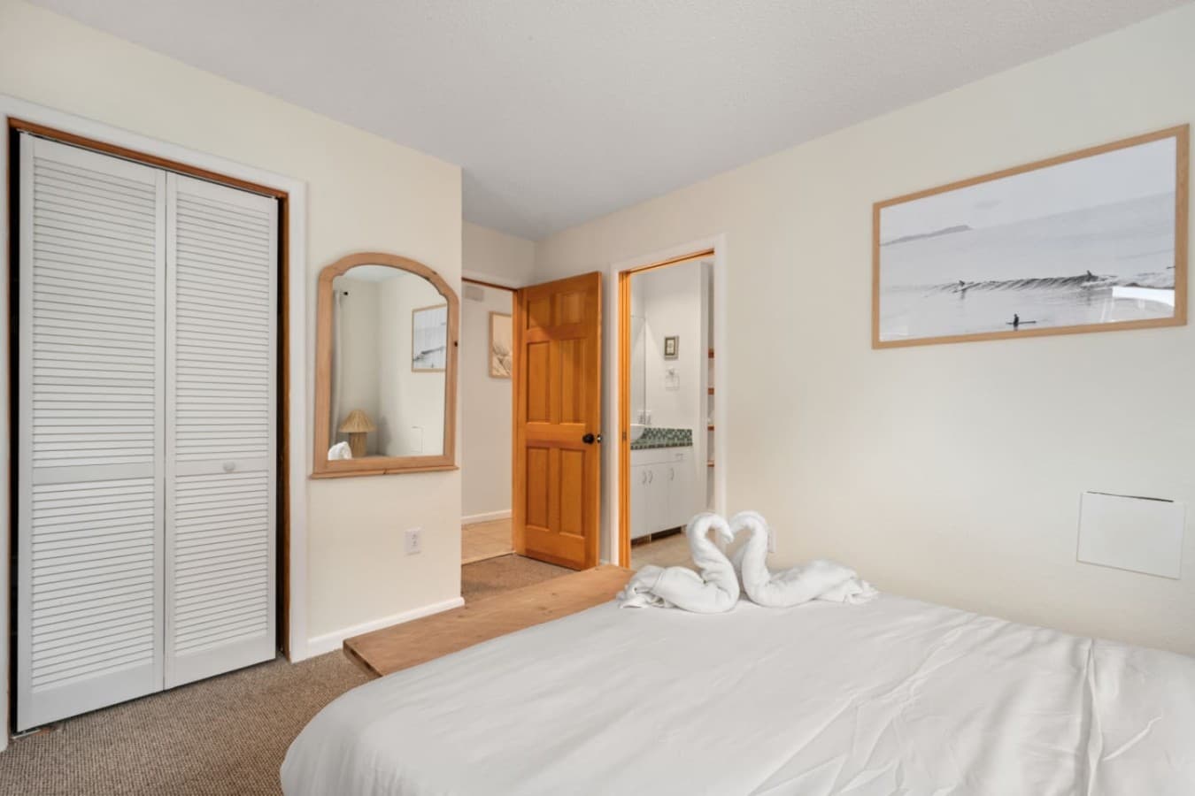 Serene bedroom w/ soft textures, warm accents & a calming coastal feel.