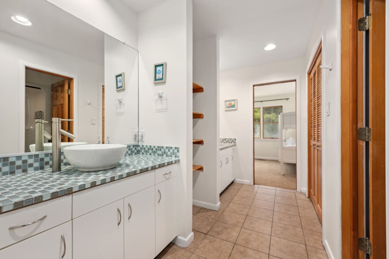 Clean bathroom vanity w/ granite counter & bright, fresh finishes.