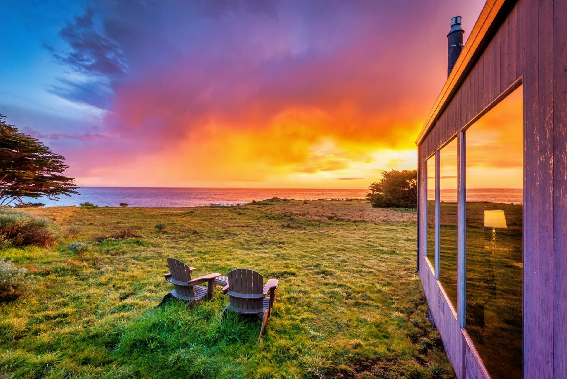 "The home is positioned to enjoy both sunrise and sunset views." Oceanfront Adirondack chairs to watch orange sherbet sundowns reflect the quiet transition from day to dusk.