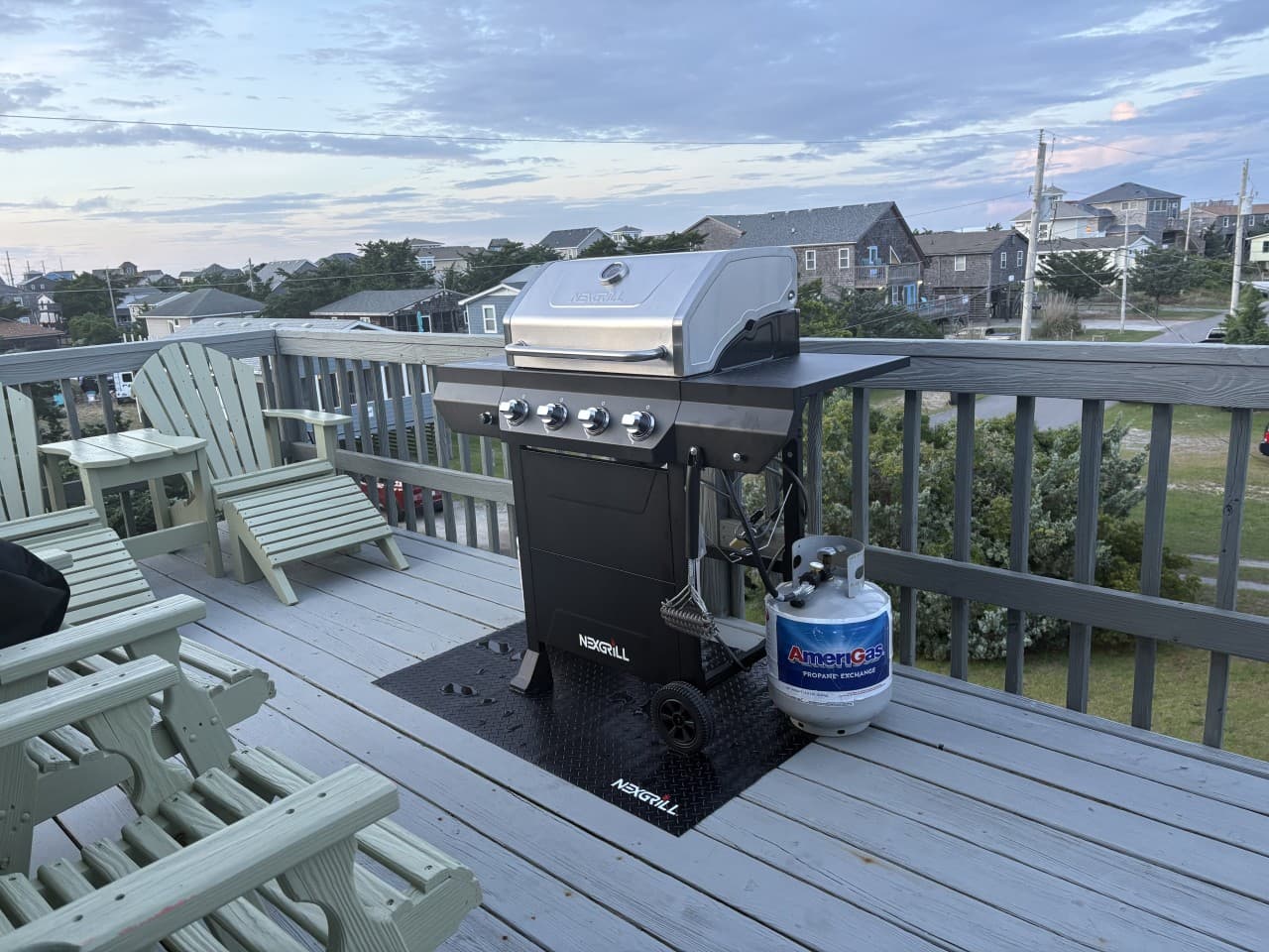 Deck grilling station w/ gas grill, propane tank & Adirondack chairs alongside for dinners out.