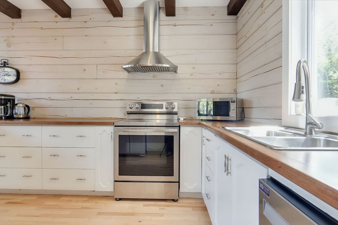 Full kitchen in main cottage. Stove and sink view