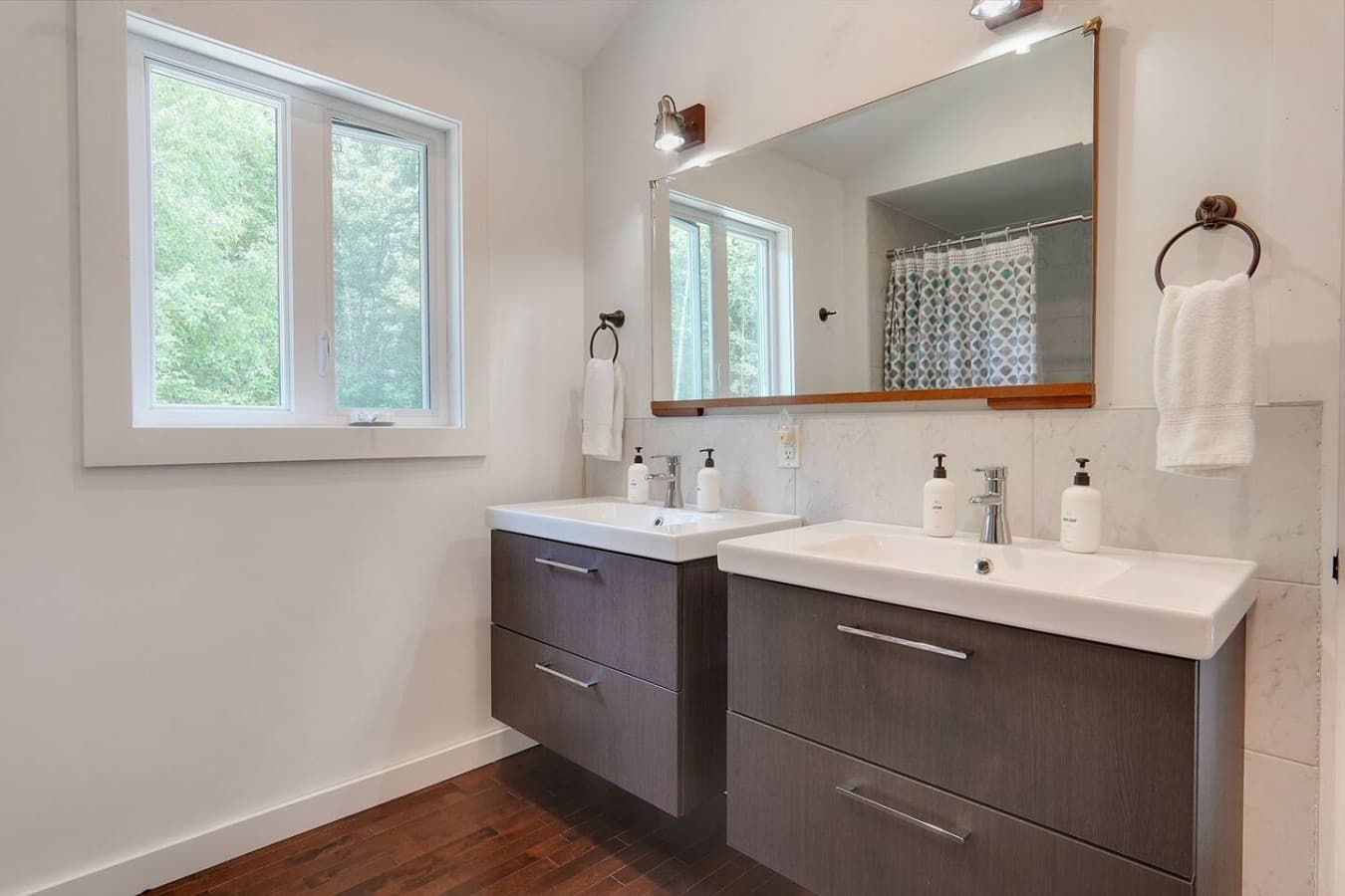 Full bathroom with double sink and tub/shower situated in the top floor of the main cottage.