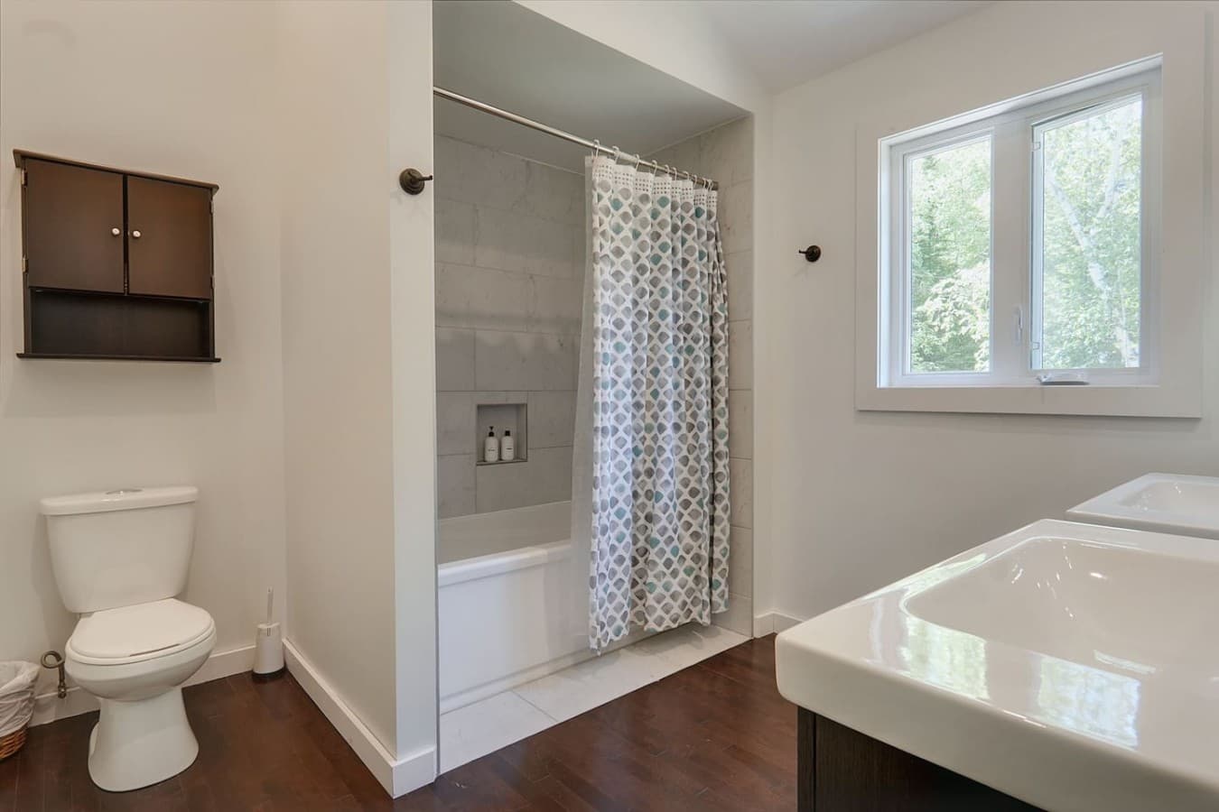 Full bathroom with double sink and tub/shower situated in the top floor of the main cottage.