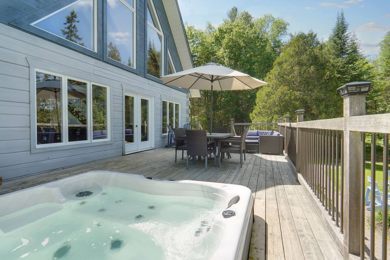 Large deck with hot tub overlooking the lake