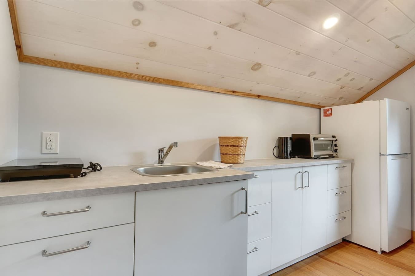 Kitchenette in Bunkie. Features an Electric stove top and mini oven + fridge