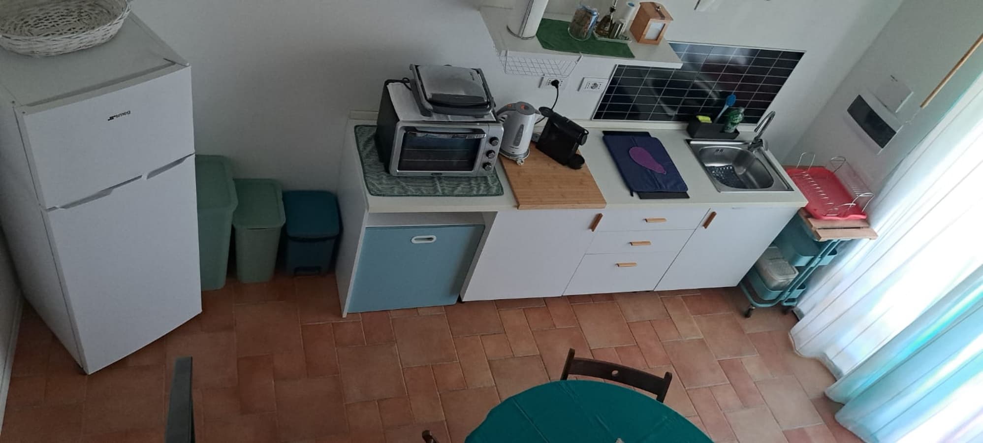 from this old photo you see the patio outside, a table for breakfast, a dining area under the gazebo