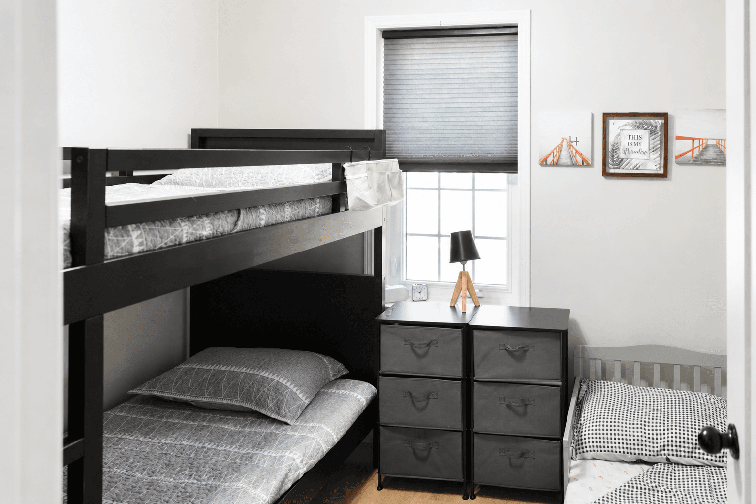 Family-friendly third bedroom featuring a twin bunk and toddler bed, suitable for both kids and adults.