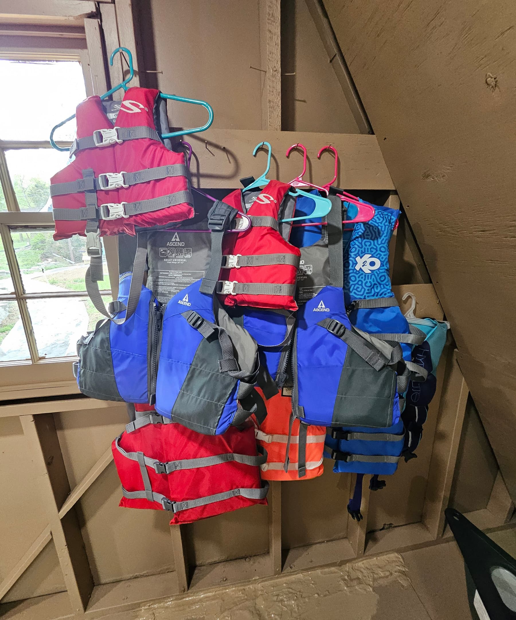 A variety of adult and child life vests are located in the boathouse.