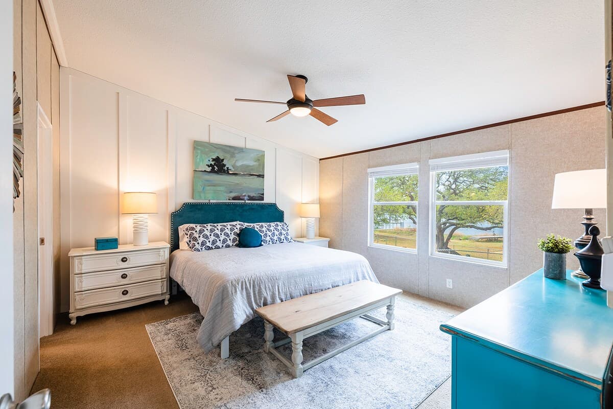 Spacious master bedroom with a comfortable queen bed—your peaceful retreat after a day on the lake or trails.