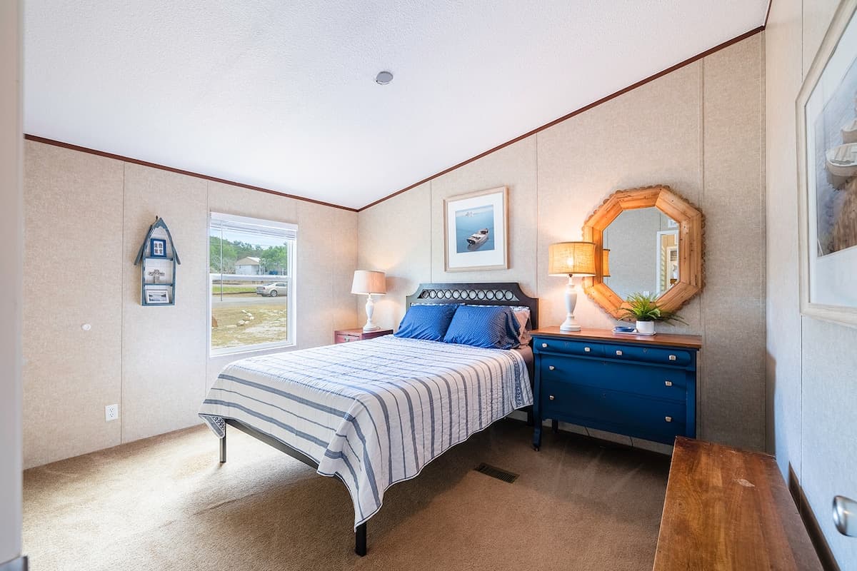 Cozy queen bedroom with soft bedding for a peaceful night’s rest after lake or trail adventures.