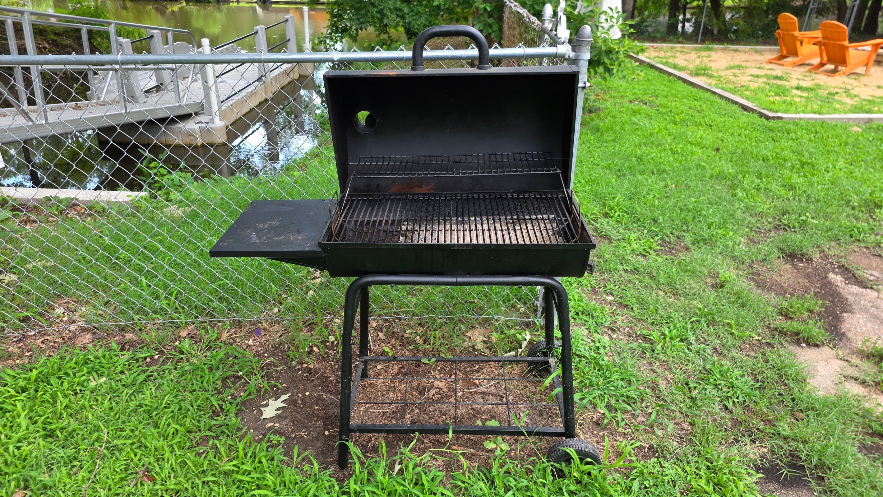 Grill up some meats on the charcoal grille  in the backyard