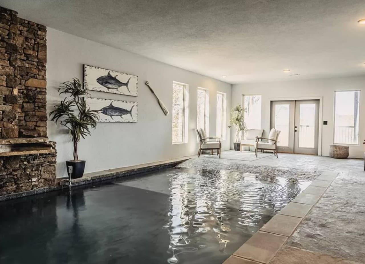 Indoor heated swimming pool downstairs, that leads to balcony downstairs