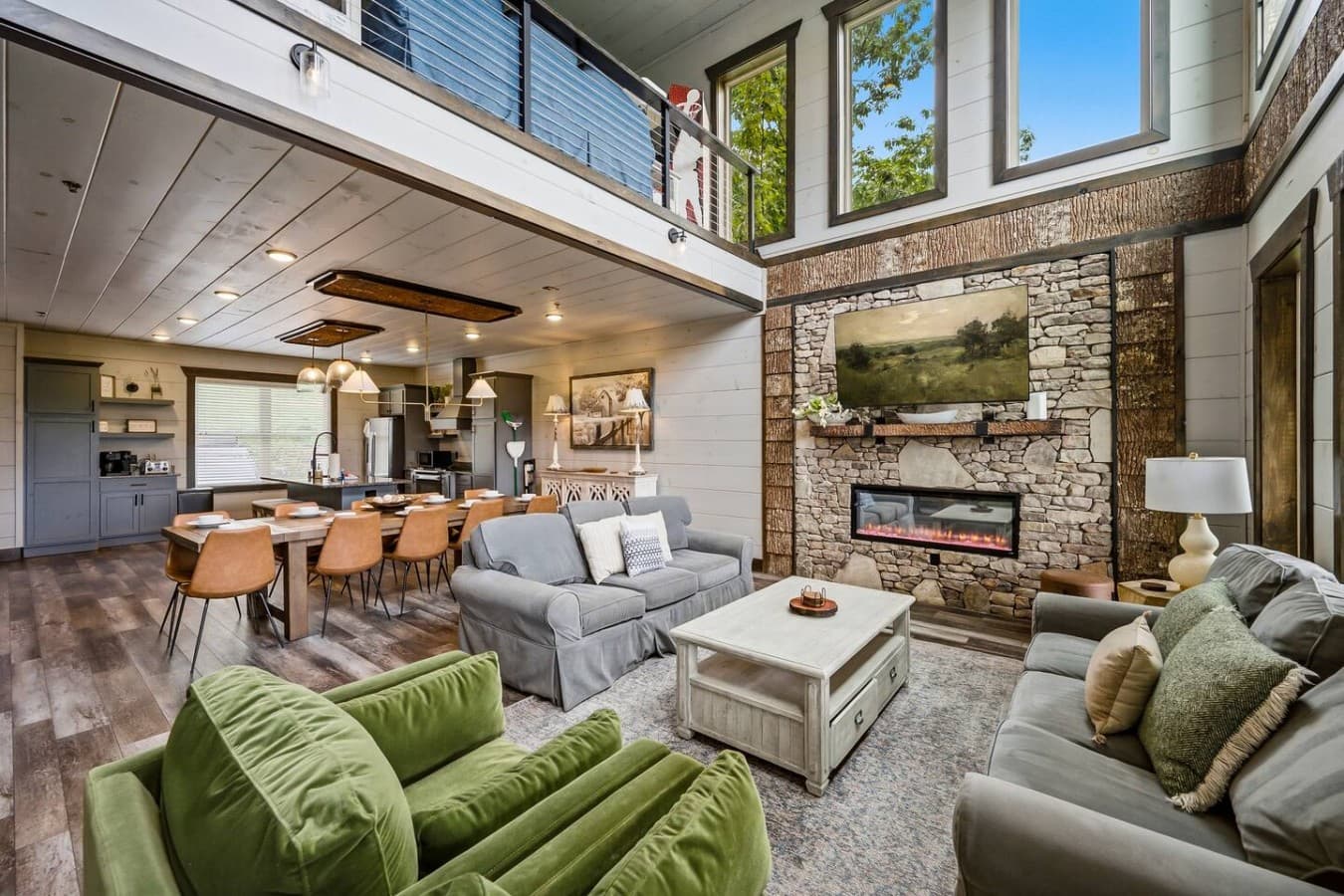 An expansive and open main level concept with large windows and a cozy fireplace