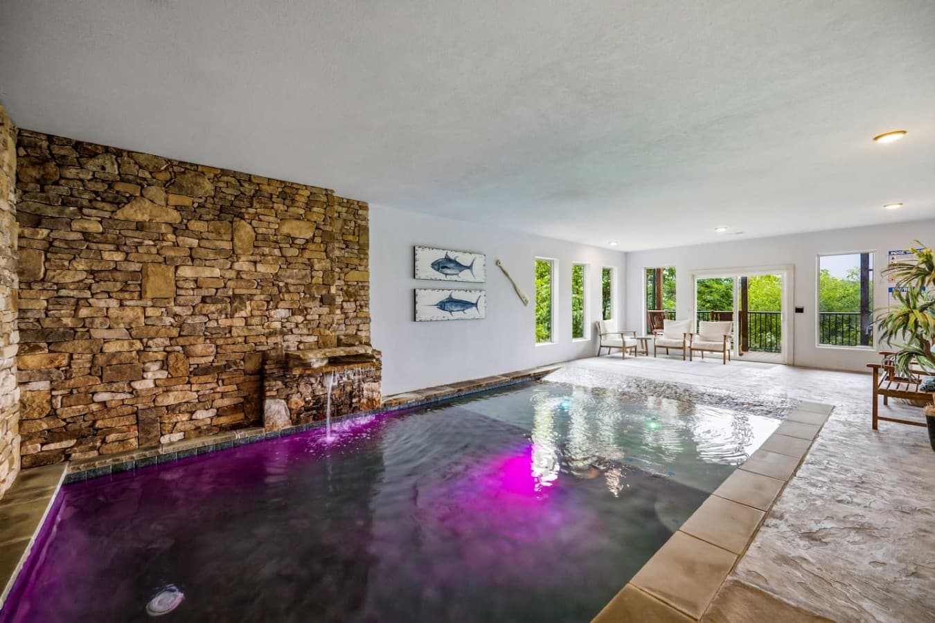 A thoughtfully designed indoor heated pool with zero entry, lights and a waterfall!