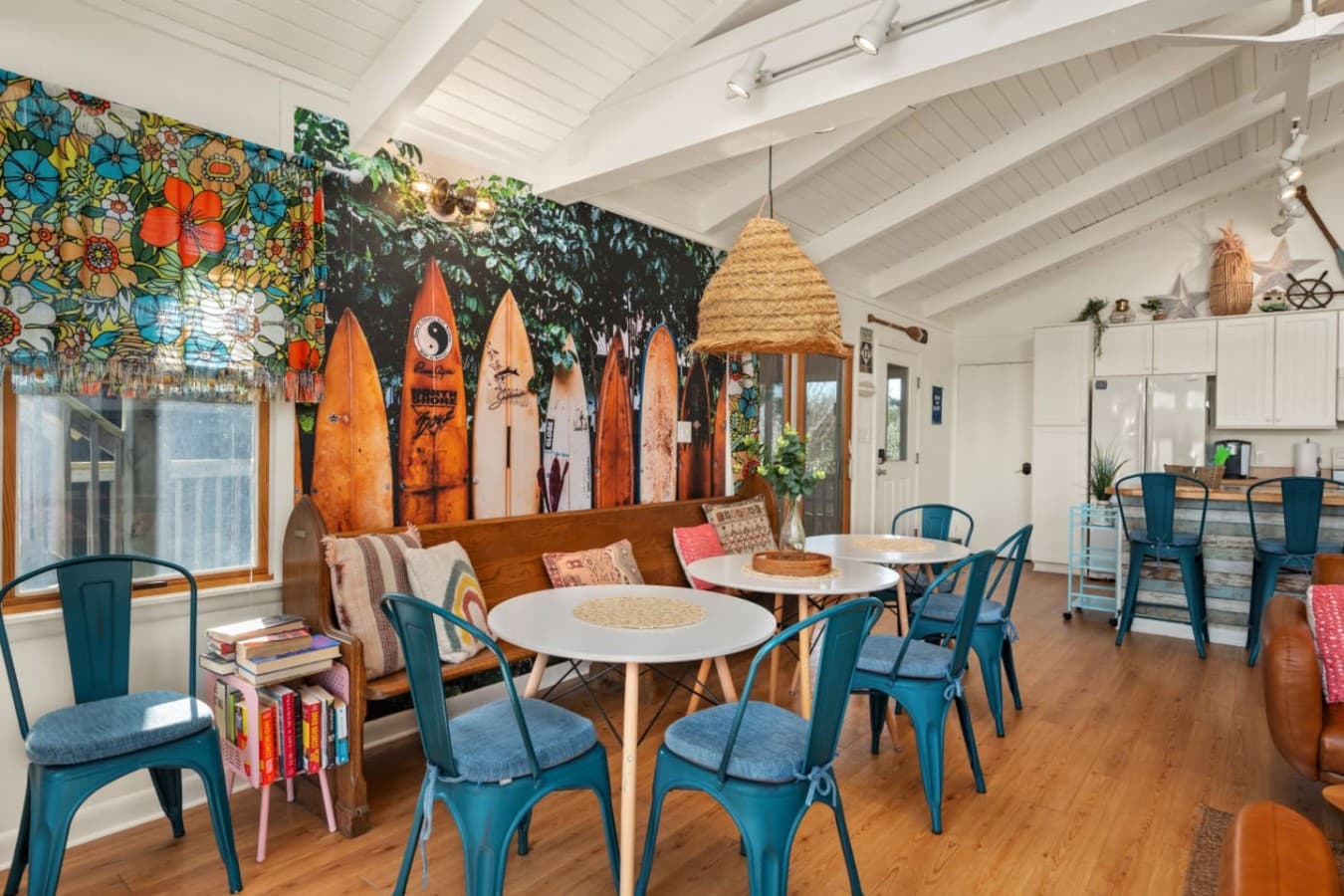 Colorful dining area w/ playful decor, statement lighting & a relaxed spot to gather over meals.