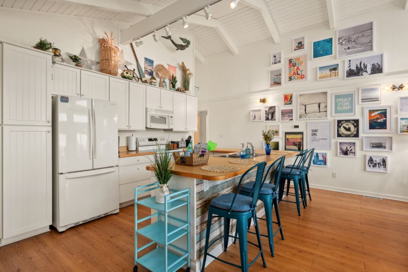 Bright kitchen wall w/ clean cabinetry, art accents & a cheerful, lived-in feel.