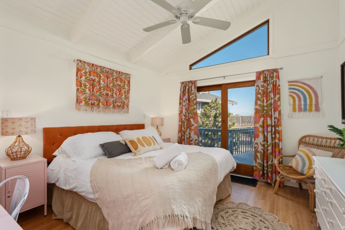 Serene bedroom w/ cozy bedding, colorful art & a relaxed coastal vibe.