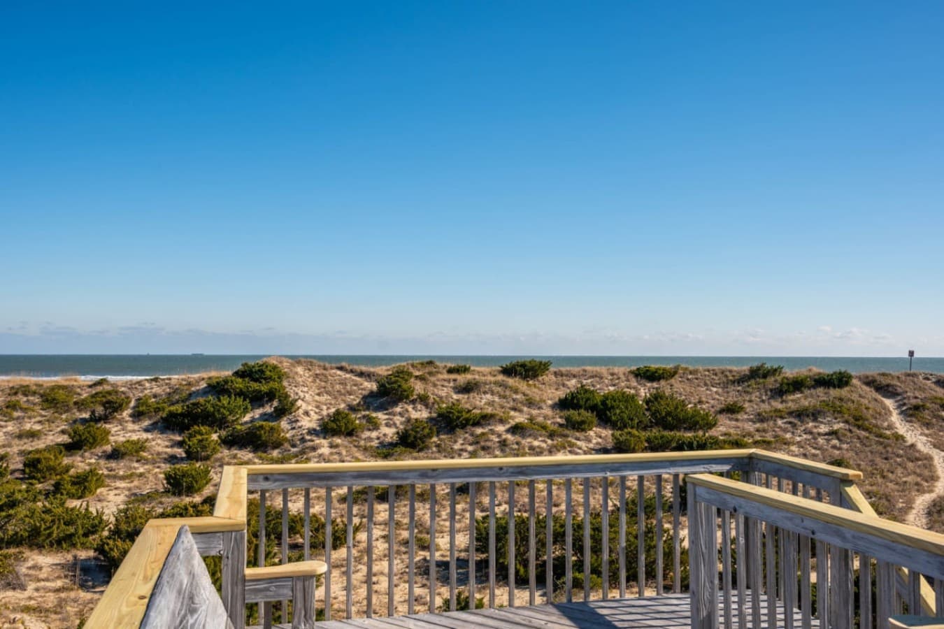 Open deck overlooking dunes & rooftops, perfect for soaking up sunshine & coastal air.