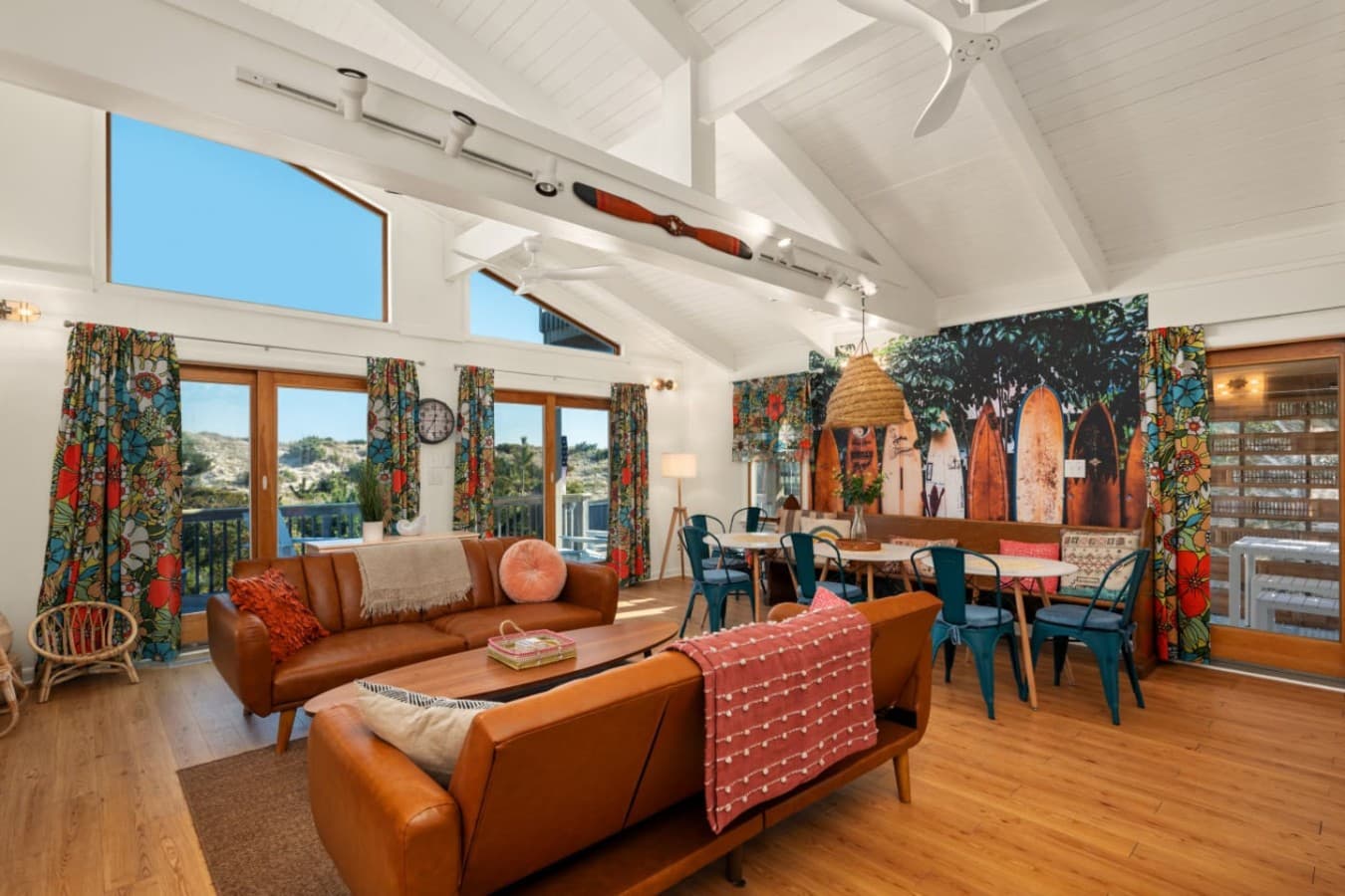 Sunlit dining area w/ bold colors, woven lighting & views into the living space.
