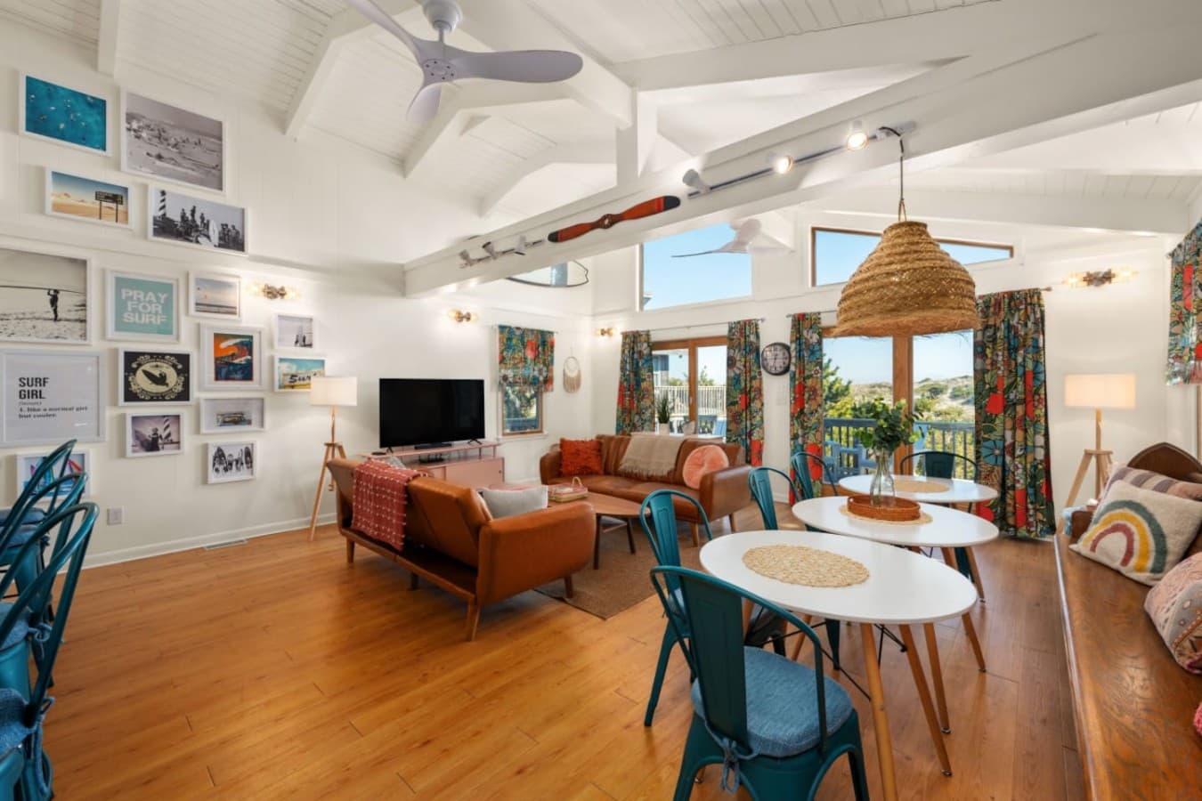 Spacious living area w/ multiple seating zones & windows that bring the outdoors in.