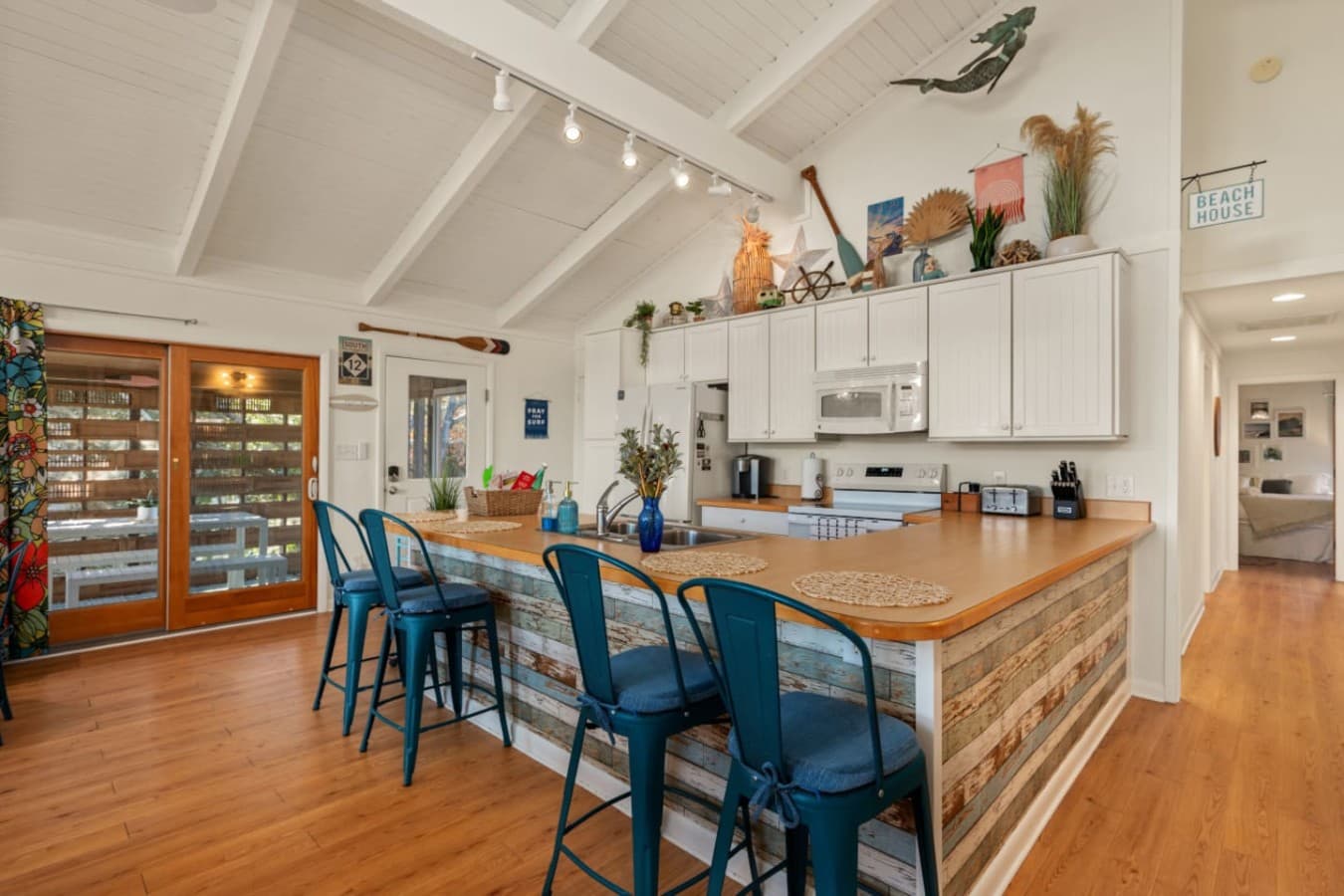 Open kitchen w/ wood island, bar seating & easy flow into the dining and living areas.