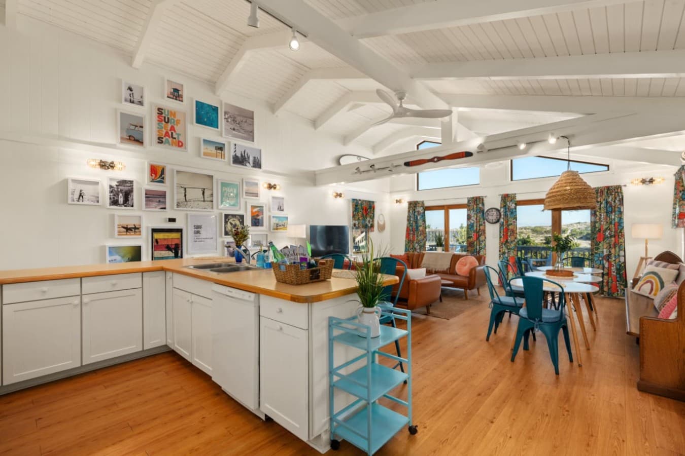 Wide view of the kitchen, dining & living spaces designed for easy group living.