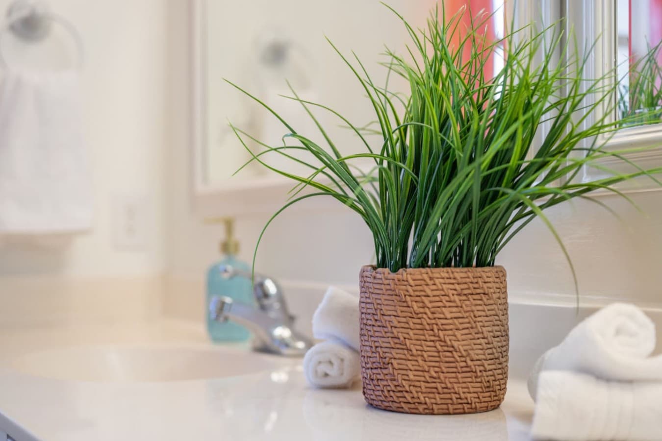 Fresh bathroom details w/ greenery, soft light & clean finishes for a spa-like feel.