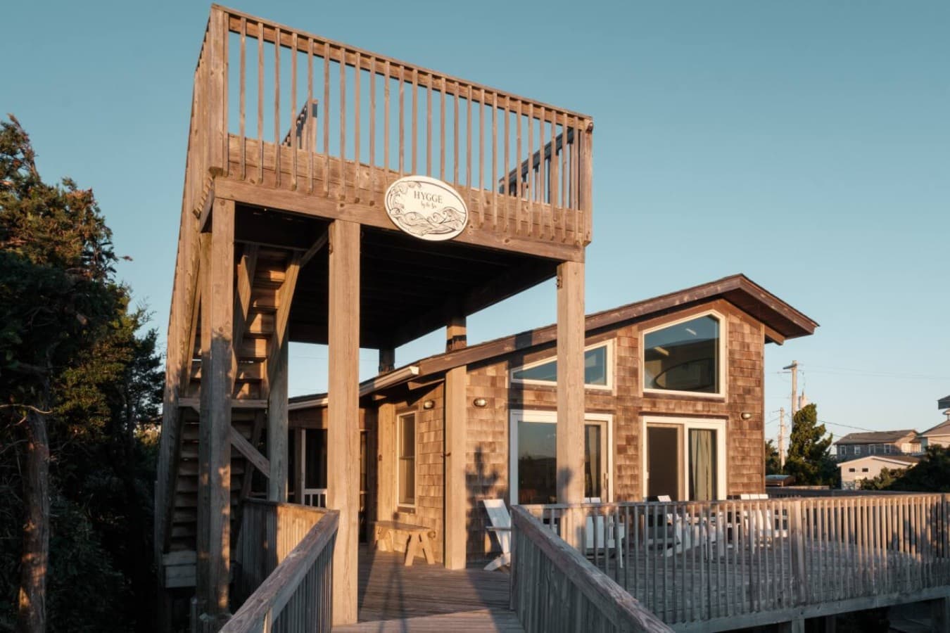 Cedar-shake cottage w/ its raised lookout deck, boardwalk & wraparound sun deck.