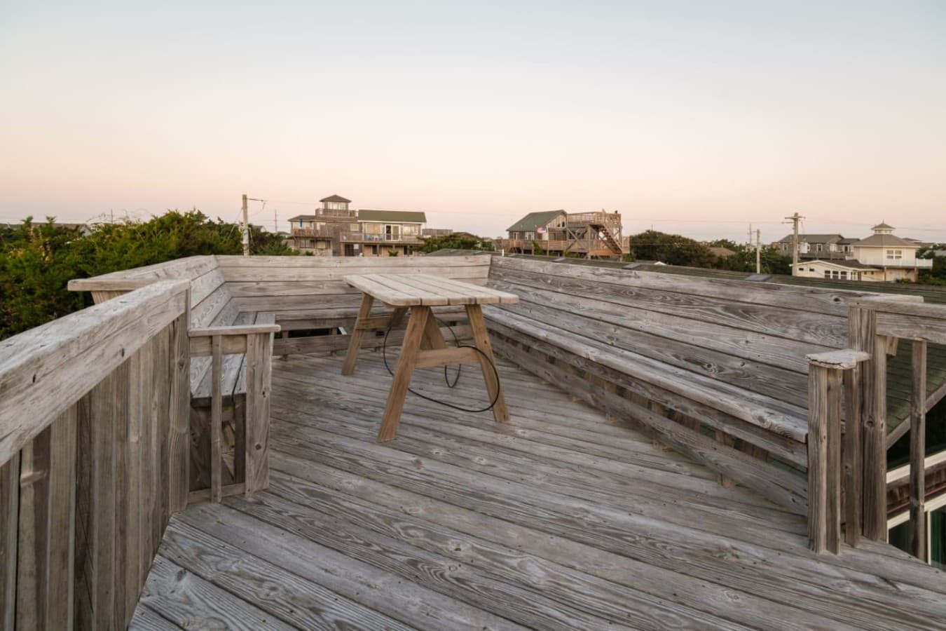 Rooftop deck at dusk w/ built-in benches — an easy spot to catch the evening sky.