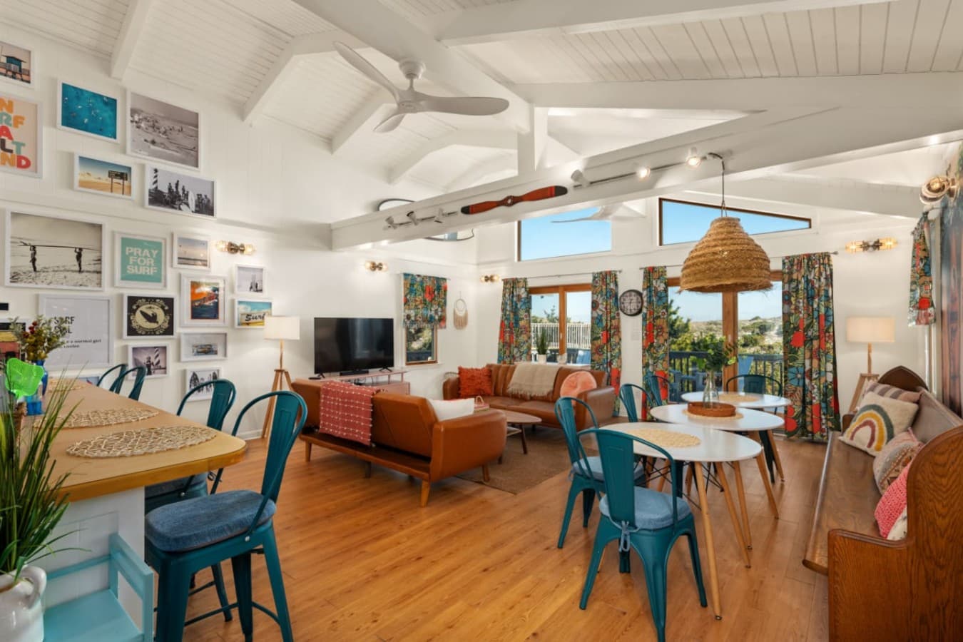 Spacious open-concept living area w/ colorful seating, layered textures & room to gather.