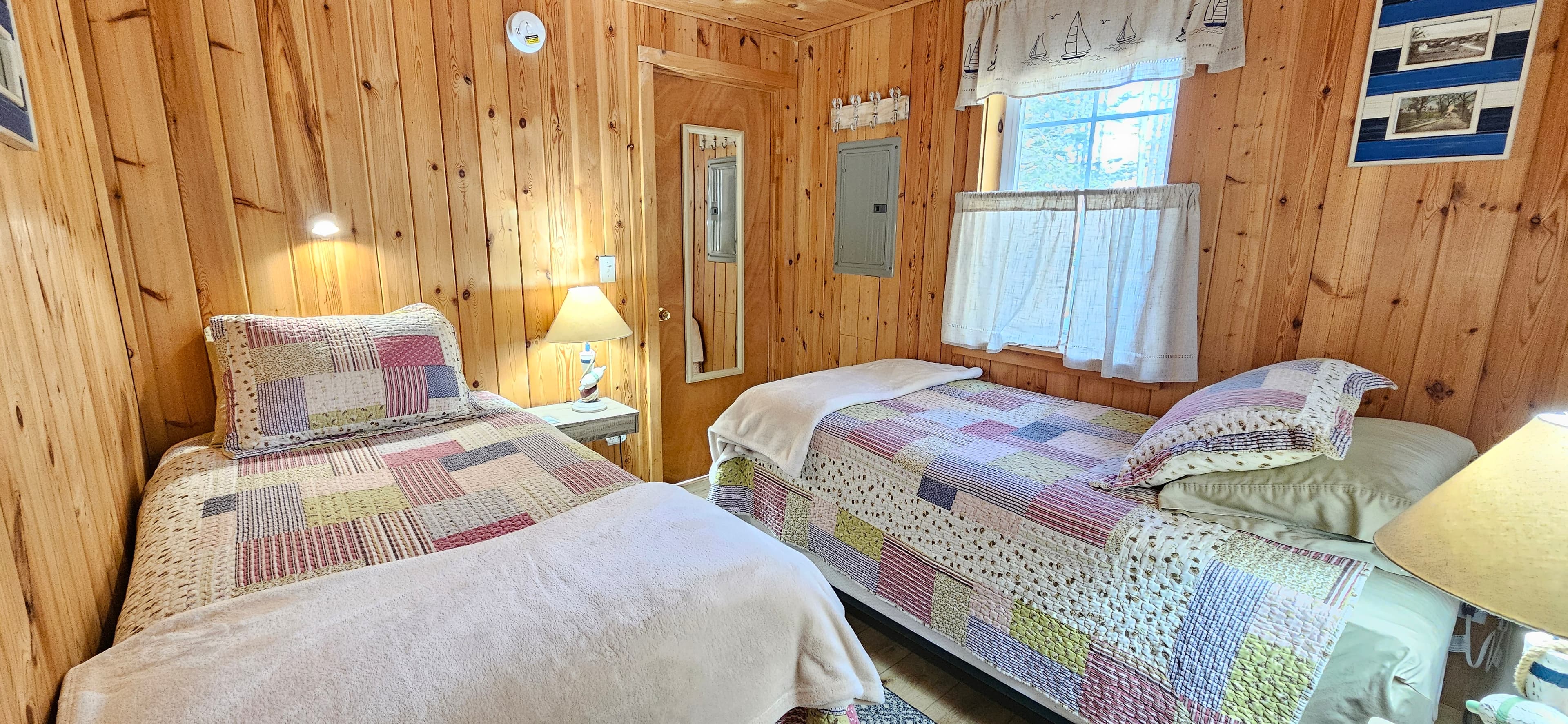 Second bedroom featuring two cozy twin beds, ideal for family or kids