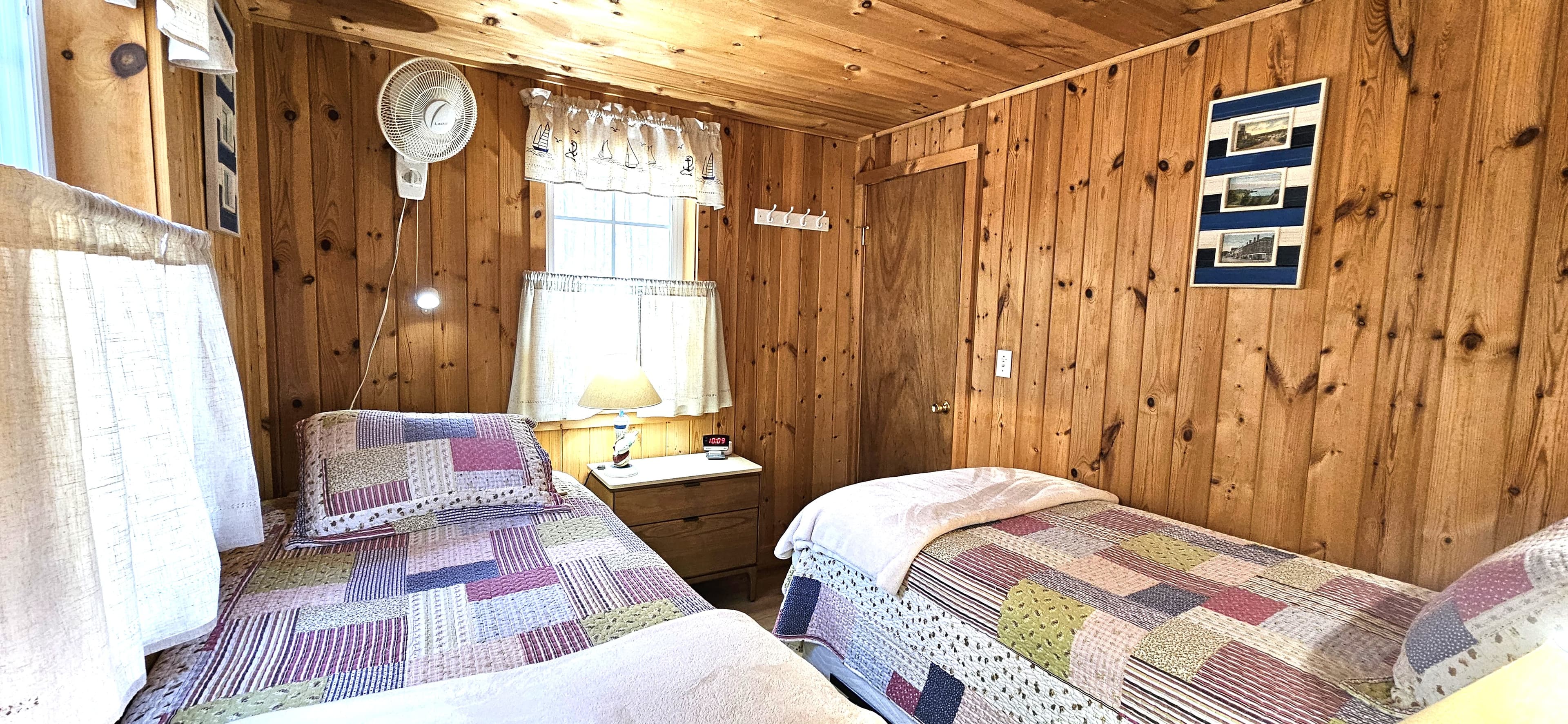 Second bedroom with closet, room darkening shades, heater and ceiling fan. 