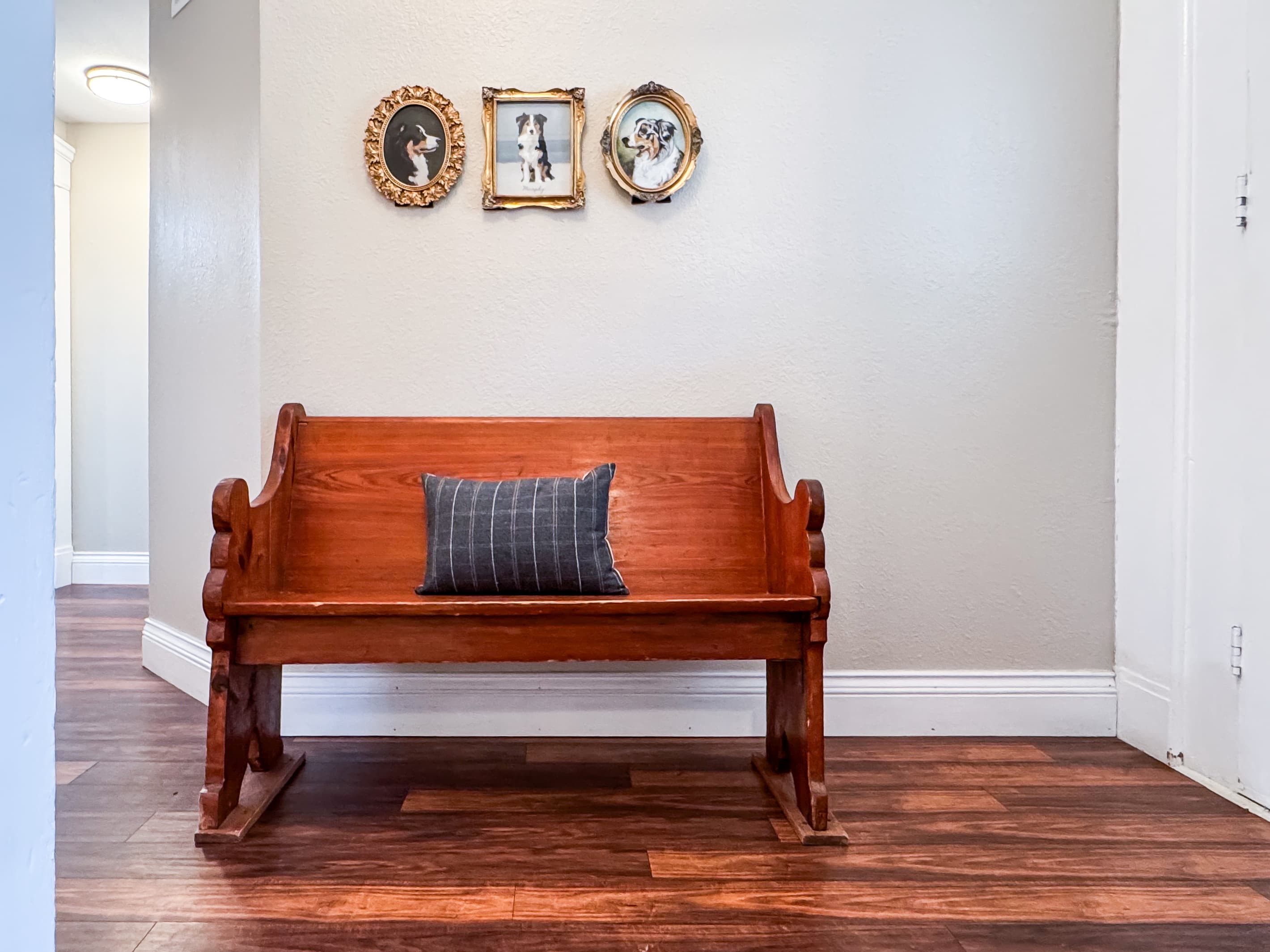 Over a century old, the home has been updated to modern conveniences, includes a charming hallway with a church pew at Mini Aussie Cottage.