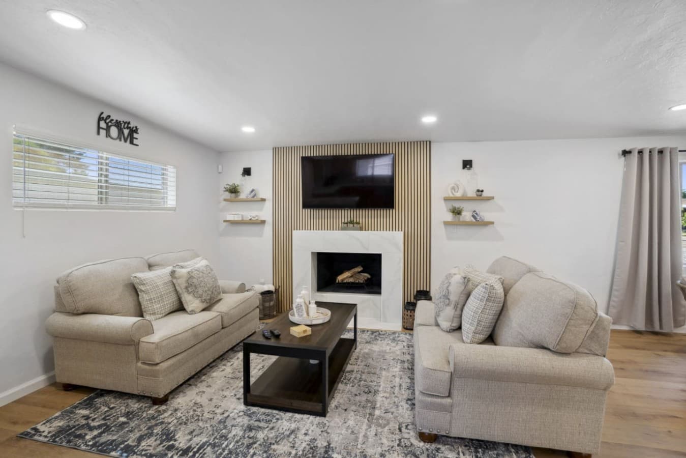 Inviting living room w/ cozy seating, fireplace & warm finishes for relaxed evenings together.