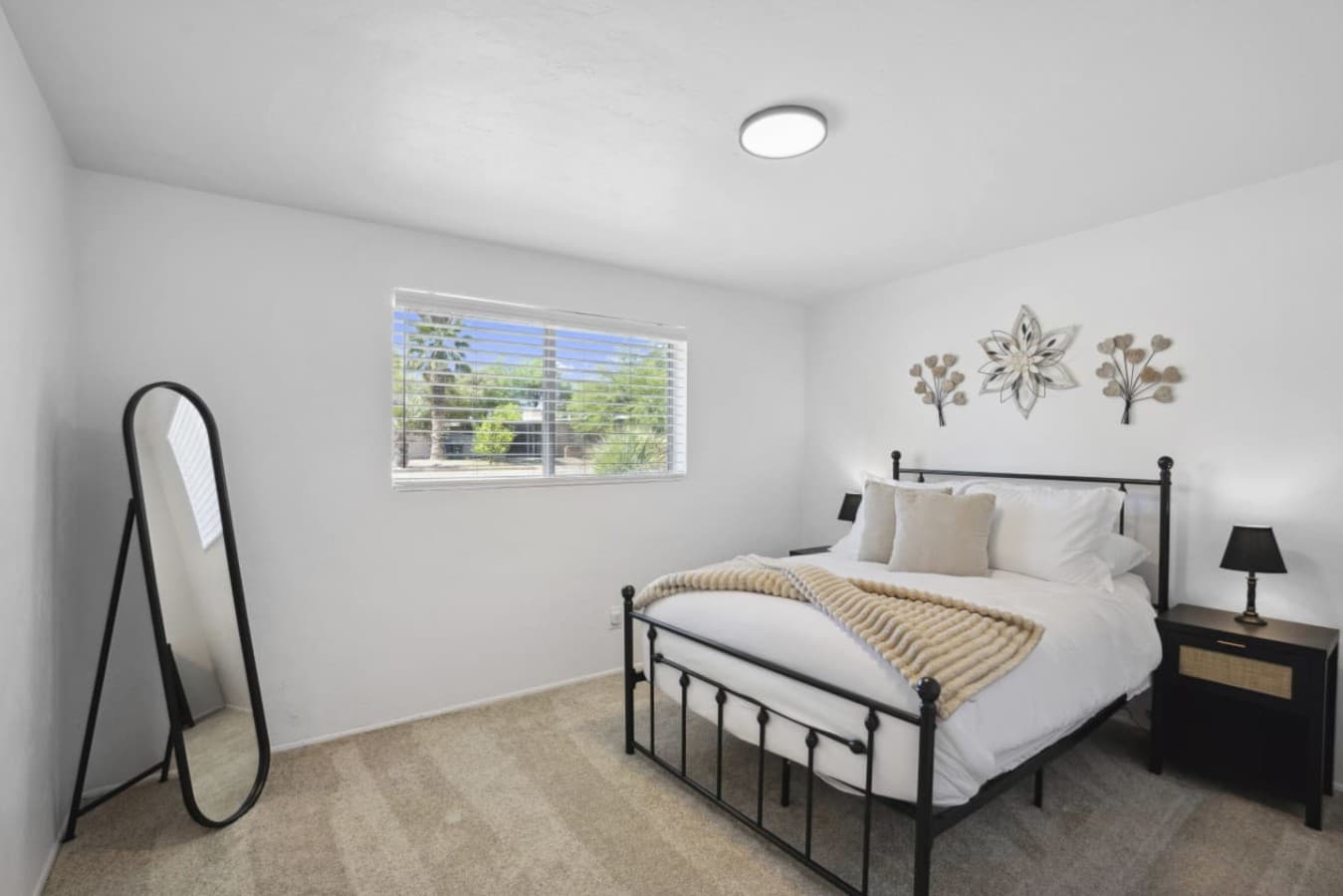 Comfortable bedroom w/ clean lines, soft light & a peaceful atmosphere.