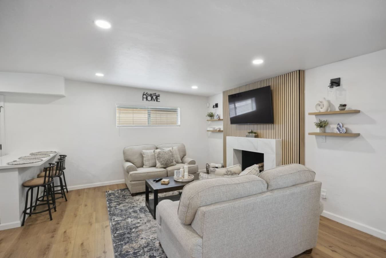 Cozy living room w/ fireplace, layered seating & a welcoming place to unwind.